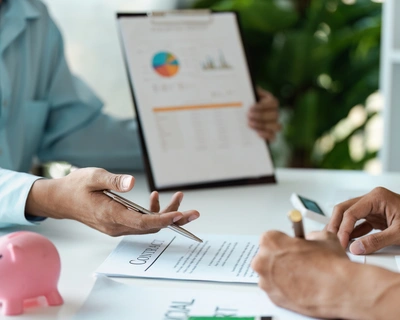 A young couple discussing financial planning and signature with Documents and Adviser Financial